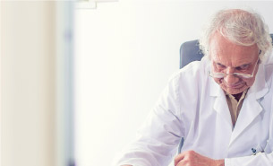 Optometrist sitting at his desk.