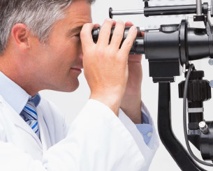Optometrist looking through exam equipment.